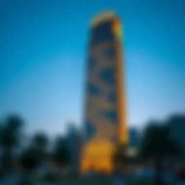 A stunning view of Capricorn Tower at dusk, showcasing its illuminated facade against the evening sky.
